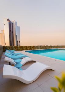 a swimming pool on the roof of a building at Tranquil Wellness Tower By Wellcube in Dubai
