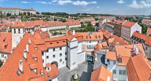 an aerial view of a city with red roofs at Augustine Hotel, Prague in Prague
