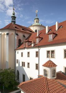 a white building with a red roof at Augustine Hotel, Prague in Prague