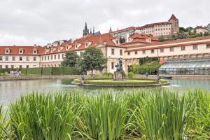 a fountain in front of a large building at Augustine Hotel, Prague in Prague
