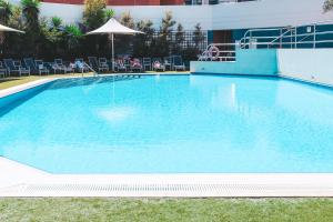 a large swimming pool with blue water at Residence on Langley Park in Perth
