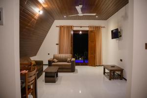 a living room with a couch and a chair at King coco villa in Tangalle