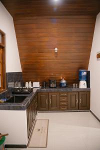 a kitchen with a counter top and a wooden ceiling at King coco villa in Tangalle
