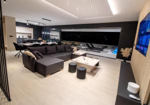 a living room with a couch and a table at Villa Solis in Novalja