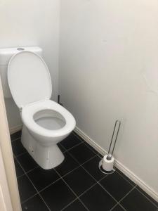 a white toilet in a bathroom with a mop at Manors Bvld in Wyndham Vale
