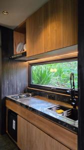 a kitchen with a sink and a window at The Bataran Studio in Gitgit +16 photos