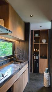 a kitchen with a sink and a counter top at The Bataran Studio in Gitgit
