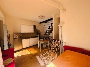 a room with a kitchen and a living room at Friendly Africa Room Como Center in Como