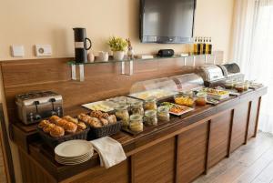 a buffet with a lot of food on it at Hotel Hartig in Prague