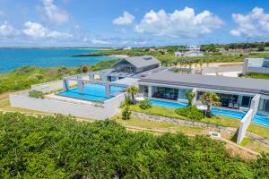 an aerial view of a house with a swimming pool at アルカディアリゾート宮古島 in Irabu