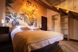 a bedroom with a large bed with a mural on the wall at Le Cilodge - La Villa Lodge au cœur de Cilaos in Cilaos