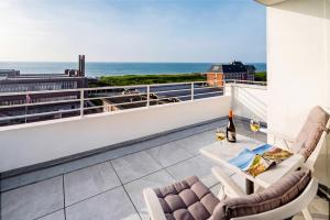 a balcony with a view of the ocean at Hotel Wiking Sylt in Westerland