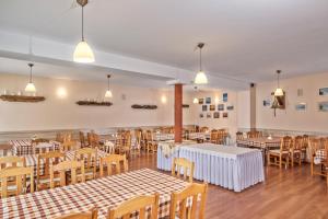 a dining room with tables and chairs and lights at Przystań u Kapitana in Ustka