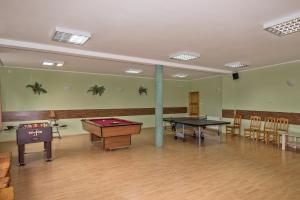 a room with two ping pong tables and chairs at Przystań u Kapitana in Ustka
