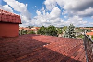a balcony with a wooden floor and a fence at Przystań u Kapitana in Ustka +6 photos