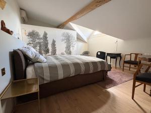 a bedroom with a bed and a dining room at Les Suites du Midi in Saint-Paul-dʼEspis +47 photos