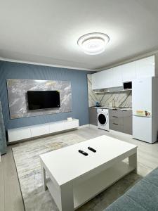 a kitchen with a white table and a white refrigerator at Gegee's House in Ulaanbaatar +10 photos