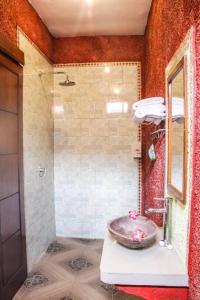 a bathroom with a sink and a shower at Reynold Artha Guest House in Nusa Lembongan