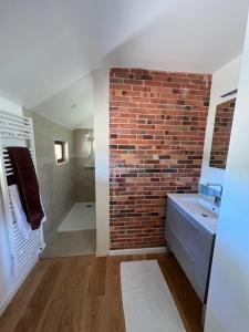 a bathroom with a brick wall and a sink at Gîte Les Moreaux in Saint-Amand-en-Puisaye +13 photos