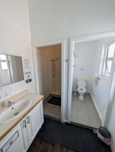 a bathroom with a sink and a toilet at The Gympie Empire in Gympie +18 photos