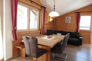 a dining room with a wooden table and chairs at Ferienhaus Wöscher in Kaltenbach