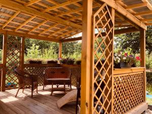 a wooden pergola with chairs and a table on a deck at Pension Nazli Lübeck in Lübeck
