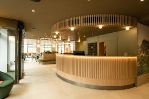 an office lobby with a large circular bar in the middle at Hôtel le Square in Geneva