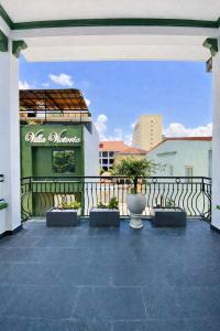 a patio with a fence and a building at Victoria Villa 2 in Hue