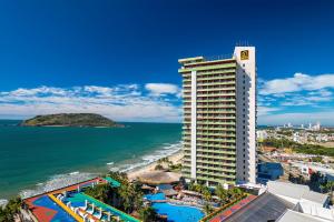 a view of a hotel and the beach with the ocean at El Cid El Moro Beach in Mazatlán