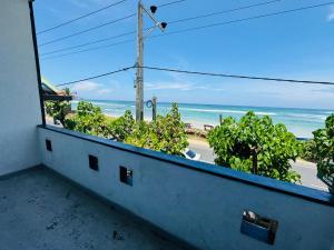 a balcony with a view of the ocean at Hotel Lean at 83 in Ahangama