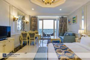 a hotel room with a bed and a table and chairs at Lan Rung Beach Resort in Long Hai