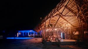 a lit up building with a pavilion at night at Mangoverde Guesthouse in Moalboal