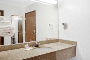 a bathroom with a sink and a mirror at Days Inn by Wyndham Dyersburg in Dyersburg +74 photos