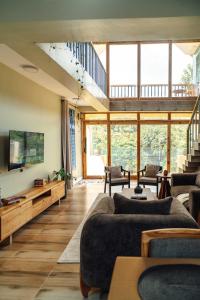 a living room with a couch and a tv at Starico Residence in Nkoanrua