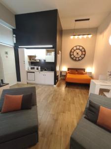 a living room with a couch and a kitchen at Loft 18A Roma - Casa con ingresso indipendente e parcheggio gratuito in Rome +18 photos