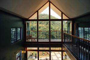 a room with a large window and a balcony at Starico Residence in Nkoanrua