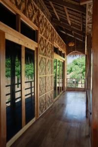 an empty room with wood floors and windows at Kayan Siargao in General Luna +12 photos