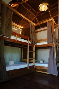 two bunk beds in a room with a ceiling at Kayan Siargao in General Luna