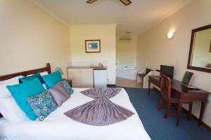 a hotel room with a bed and a desk and a desk at Tree Top Walk Motel in Walpole