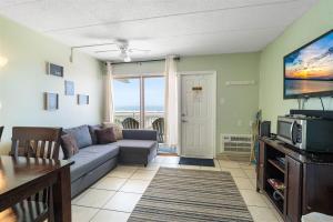 a living room with a couch and a tv at Oceanfront Condo w Heated Pool & Reserved Parking in Wildwood Crest