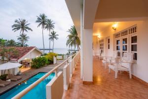 a view from the balcony of a resort with a swimming pool at Shangrela Beach Resort by ARK in Ambalangoda