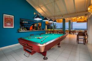 a pool table in a room with a bar at Shangrela Beach Resort by ARK in Ambalangoda