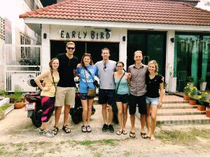 a group of people standing in front of a building at Early Bird Hostel Ayutthaya in Phra Nakhon Si Ayutthaya