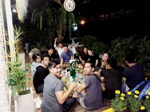 a group of people sitting around a table at Early Bird Hostel Ayutthaya in Phra Nakhon Si Ayutthaya