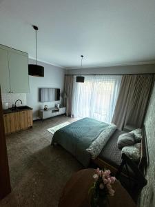 a bedroom with a bed and a large window at Studio 102 Garden in Krakow +2 photos