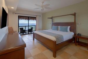 a bedroom with a bed and a view of the ocean at Catalonia Yucatan Beach - All Inclusive in Puerto Aventuras +51 photos