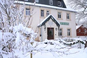 a building with snow on the ground in front of it at Erzhof Nassau- Gästezimmer an der Loipe in Bienenmühle +4 photos