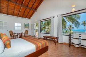 a bedroom with a bed and a view of the ocean at Shangrela Beach Resort by ARK in Ambalangoda +82 photos