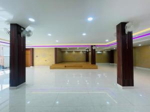 a large room with two columns and a stage at Executives palace in Rāmgarh