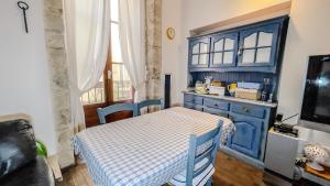a kitchen with a table and a blue cabinet at La Baita nel Borgo HOWME in Bari